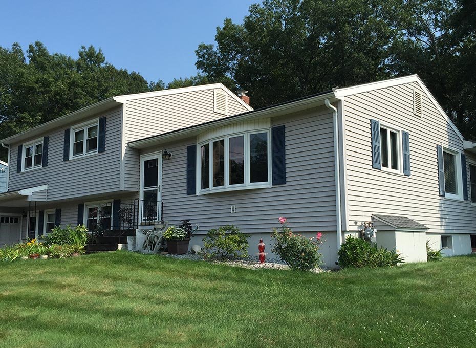 Split-level home with grey siding and white trim