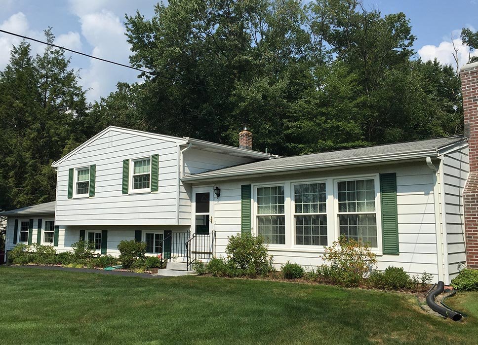 White ranch home with green shutters